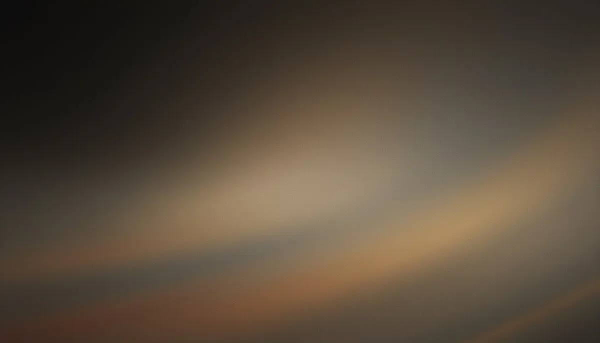 A continuous mesh gradient drifts from deep warm charcoal in the upper left toward a diffuse, muted amber warmth in the lower center, the tones melting imperceptibly into one another across a grain-textured field.