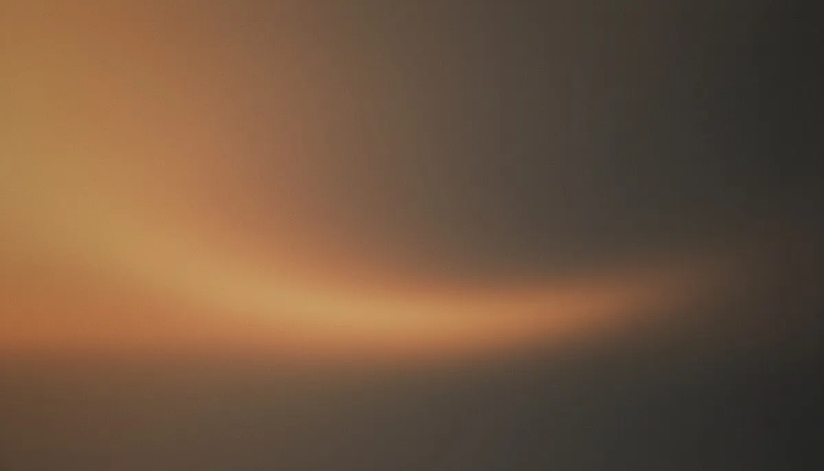 A muted mesh gradient drifts from hazy amber warmth in the upper left through clay and taupe into deep charcoal shadow, evoking the slow arc of a day's light from dawn to dusk.